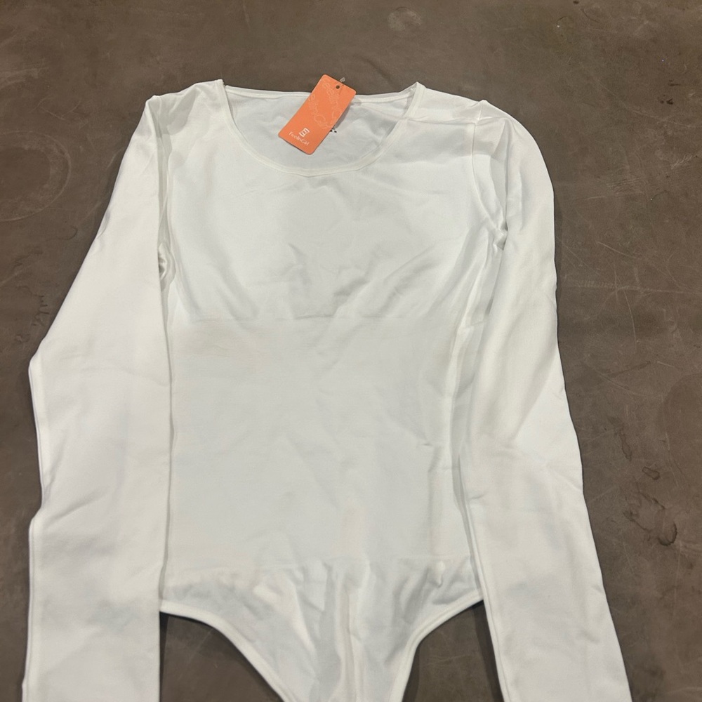 Woman’s unworn longsleeve white tumy control bodysuit tag on